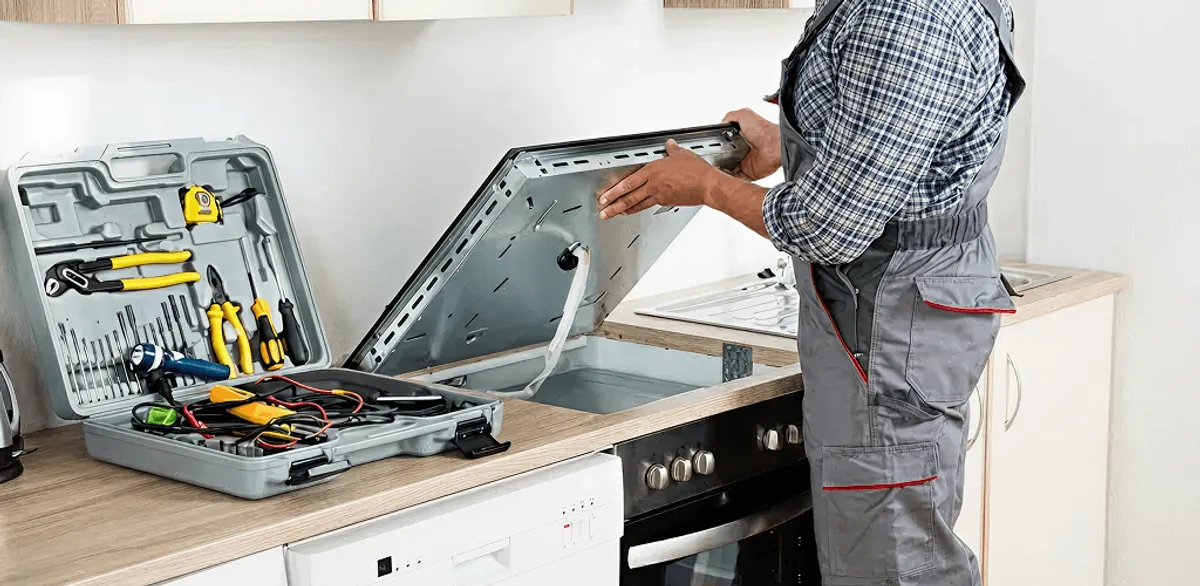 Handyman repairing a cooktop and checking wiring connections in Toledo, OH