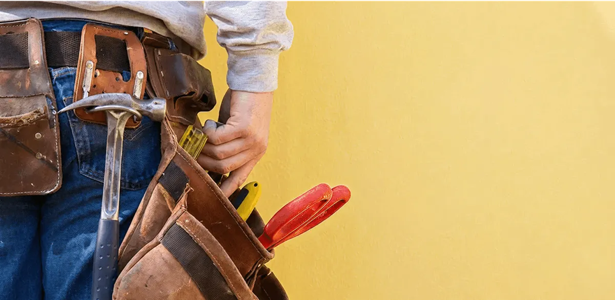 Handyman with tool belt ready for home repairs and maintenance in Toledo, OH