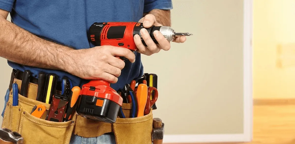 Handyman holding a power drill for home repairs and installations in Toledo, OH